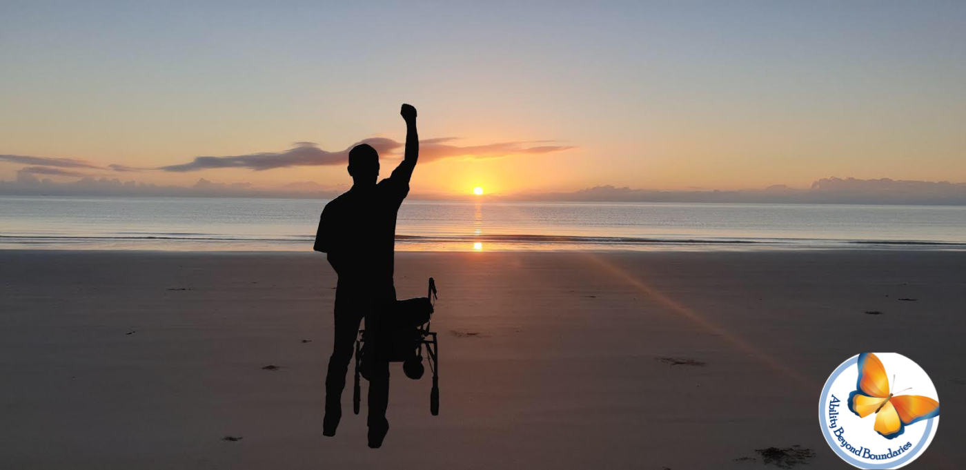 Sunrise near the ocean with a man standing with his walker while he has his right hand raised powerfully